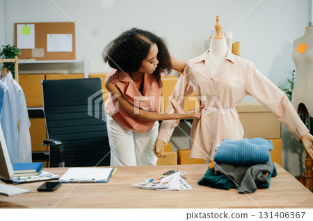 Young influencer showcasing clothing in a creative workspace, highlighting ecommerce, digital marketing 131406367