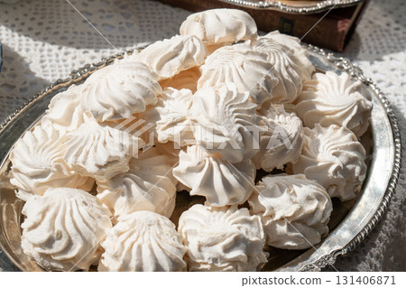 Close-up of classic white Russian zefir on a vintage silver tray in natural daylight Close-up of classic white Russian zefir on a vintage silver tray in natural daylight 131406871