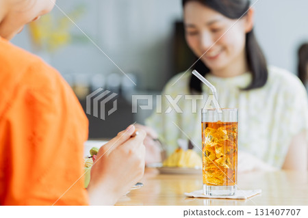 Young woman having tea with friends in cafe Young woman having tea with friends in cafe 131407707