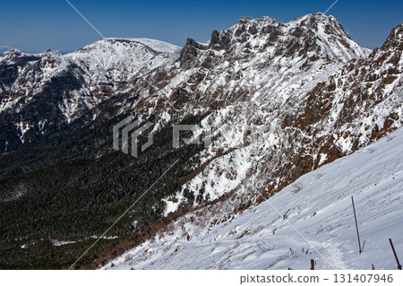 Climbers walking along the Bunzaburo Trail and the Yatsugatake Mountain Range, Mt. Yokodake, Mt. Iodake and Mt. Tengu 131407946