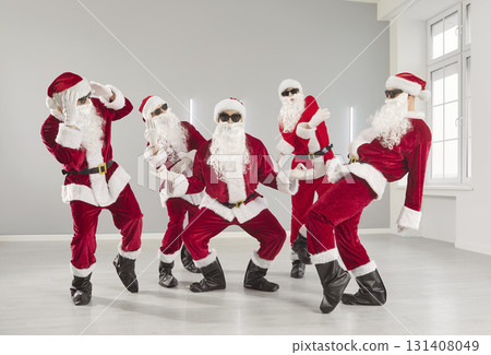Santas wearing red costumes, dancing modern dance, having fun on party, celebrating New Year Santas wearing red costumes, dancing modern dance, having fun on party, celebrating New Year 131408049