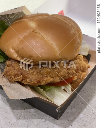 A mouthwatering burger with a juicy patty, fresh lettuce, tomato, and melted cheese, all nestled in a soft bun. Perfect for food photography, showcasing the indulgence of classic comfort food. 131408488
