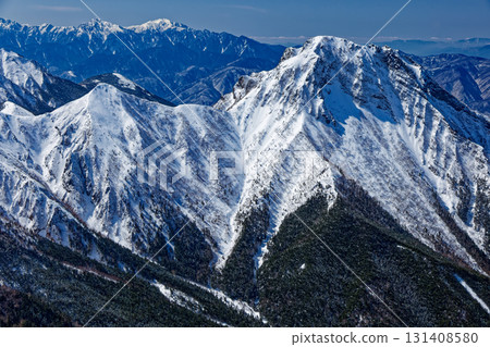 Mount Amida, Mount Kaikoma, and Mount Senjo seen from the ridge of Mount Iodake in the Yatsugatake mountain range in midwinter Mount Amida, Mount Kaikoma, and Mount Senjo seen from the ridge of Mount Iodake in the Yatsugatake mountain range in midwinter 131408580