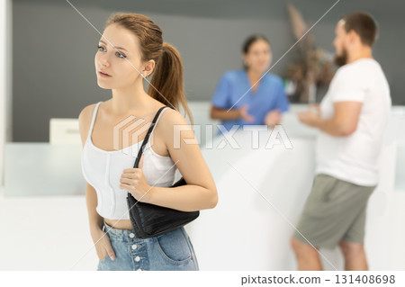 Young woman standing in dental clinic 131408698