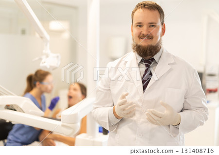 Male dentist invites you to visit dental clinic Male dentist invites you to visit dental clinic 131408716