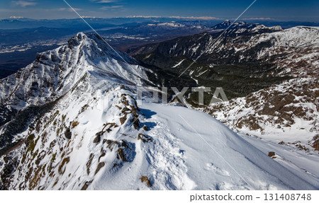 View of the Yatsugatake mountain range in midwinter from the summit of Akadake, including Mount Amida, Mount Io, Mount Tateshina, Mount Ontake, Mount Norikura, and the Yari and Hotaka mountain ranges View of the Yatsugatake mountain range in midwinter from the summit of Akadake, including Mount Amida, Mount Io, Mount Tateshina, Mount Ontake, Mount Norikura, and the Yari and Hotaka mountain ranges 131408748