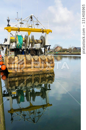A Fishing Vessel is Reflecting Beautifully in the Calm and Serene Waters of the Ocean A Fishing Vessel is Reflecting Beautifully in the Calm and Serene Waters of the Ocean 131408965
