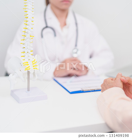 Elderly Patient consulting Doctor with Spine anatomy for Spinal Cord Disorder and disease, Back pain, Lumbar, Sacral pelvis, Cervical neck, Thoracic, Coccyx, Orthopedist, chiropractic, Office Syndrome Elderly Patient consulting Doctor with Spine anatomy for Spinal Cord Disorder and disease, Back pain, Lumbar, Sacral pelvis, Cervical neck, Thoracic, Coccyx, Orthopedist, chiropractic, Office Syndrome 131409198