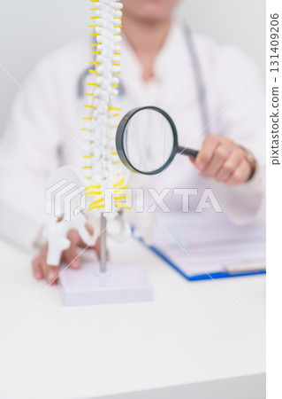 Elderly Patient consulting Doctor with Spine anatomy for Spinal Cord Disorder and disease, Back pain, Lumbar, Sacral pelvis, Cervical neck, Thoracic, Coccyx, Orthopedist, chiropractic, Office Syndrome 131409206