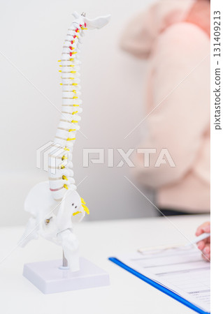 Elderly Patient consulting Doctor with Spine anatomy for Spinal Cord Disorder and disease, Back pain, Lumbar, Sacral pelvis, Cervical neck, Thoracic, Coccyx, Orthopedist, chiropractic, Office Syndrome Elderly Patient consulting Doctor with Spine anatomy for Spinal Cord Disorder and disease, Back pain, Lumbar, Sacral pelvis, Cervical neck, Thoracic, Coccyx, Orthopedist, chiropractic, Office Syndrome 131409213