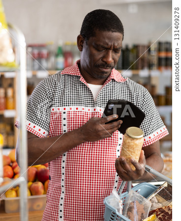 Adult man scanning qr code of beans Adult man scanning qr code of beans 131409278