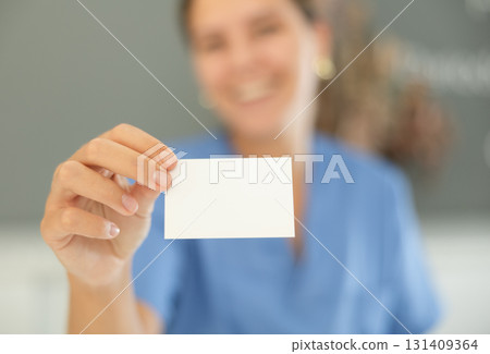 Female receptionist holding business card close up 131409364