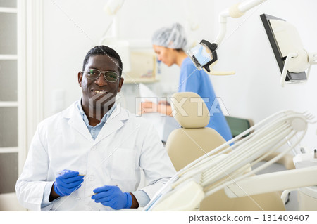 Positive african american dentist doctor in clinic Positive african american dentist doctor in clinic 131409407