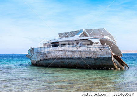 Abandoned shipwreck in clear blue ocean water under bright sky Abandoned shipwreck in clear blue ocean water under bright sky 131409537