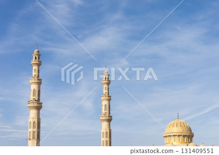 Majestic mosque minarets and dome against clear blue sky for architectural inspiration 131409551