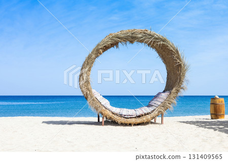 Tropical beach paradise with unique straw daybed and clear blue sky 131409565