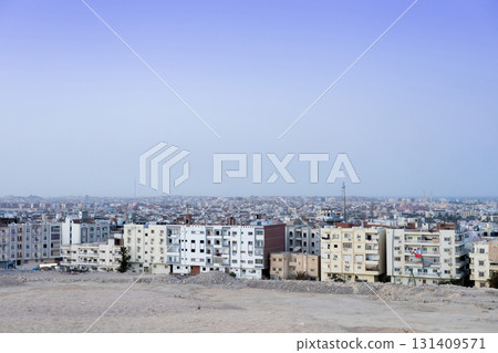 Urban landscape of expansive city skyline against clear blue sky 131409571