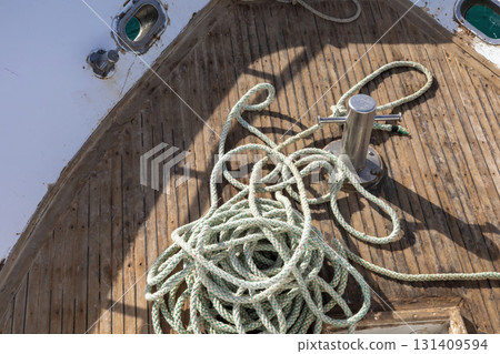 Nautical ropes on weathered boat deck for maritime themes and designs 131409594