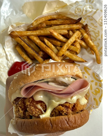 A classic combination of a juicy burger with fresh toppings served alongside golden, crispy French fries. Perfect for a satisfying meal that blends savory flavors and crunchy textures. A classic combination of a juicy burger with fresh toppings served alongside golden, crispy French fries. Perfect for a satisfying meal that blends savory flavors and crunchy textures. 131409626