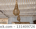 Rustic lanterns in bohemian outdoor pergola with natural light 131409726