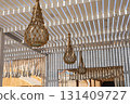 Rustic outdoor patio with woven lanterns under a slatted pergola for a cozy atmosphere 131409727