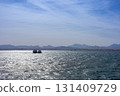 Tranquil seascape with distant mountain range under clear sky 131409729