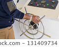 Navigating a boat with a stainless steel wheel and control panel 131409734