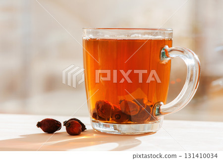 Glass cup of rosehip tea with Glass cup of rosehip tea with 131410034