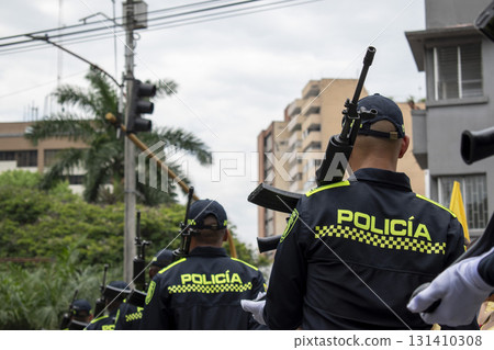 Armed Colombian police standing guard, Heavy weapons patrol in streets, Urban security enforcement officers Armed Colombian police standing guard, Heavy weapons patrol in streets, Urban security enforcement officers 131410308