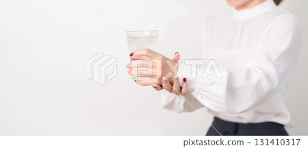 Business woman having Tremor hand during hold water glass. Parkinson disease April awareness month, Carpal Tunnel Syndrome, rheumatoid and brain injury, Neurological disorder and health care concept Business woman having Tremor hand during hold water glass. Parkinson disease April awareness month, Carpal Tunnel Syndrome, rheumatoid and brain injury, Neurological disorder and health care concept 131410317
