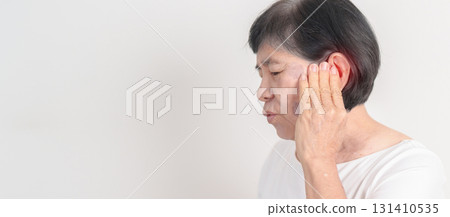 Elderly Woman having Ear pain for concept of Ear disease, Atresia, Otitis Media, Infection, Pertorated Eardrum, Meniere syndrome, Otolaryngologist, Hearing Loss, Hyperacusis, Tinnitus and Earwax 131410535