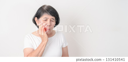 Elderly woman having Toothache and pain. Oral Teeth decay and Gum disease, Scrape off tartar. March Oral health, Dentist Day, False Teeth. Toothache and Dental Health Month and Orthodontic Health Day Elderly woman having Toothache and pain. Oral Teeth decay and Gum disease, Scrape off tartar. March Oral health, Dentist Day, False Teeth. Toothache and Dental Health Month and Orthodontic Health Day 131410541