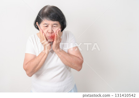 Elderly woman having Toothache and pain. Oral Teeth decay and Gum disease, Scrape off tartar. March Oral health, Dentist Day, False Teeth. Toothache and Dental Health Month and Orthodontic Health Day Elderly woman having Toothache and pain. Oral Teeth decay and Gum disease, Scrape off tartar. March Oral health, Dentist Day, False Teeth. Toothache and Dental Health Month and Orthodontic Health Day 131410542