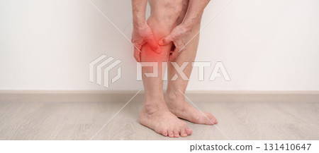 Elderly woman having Calf pain for concepts of Calf Muscle Strain, muscle pull, Leg Cramp, Sprain, aches, Varicose Veins, Deep Vein, world Thrombosis day, Senior Health care and medical treatment 131410647