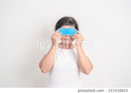 Elderly Woman with cold Eye Mask for concepts of Eye disease, Dry, Pain and Irritation eyes, Cataract, Glaucoma, Age Related Macular Degeneration, Conjunctivitis, World Glaucoma day and health 131410653