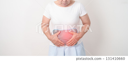 Elderly woman having abdomen aches with Hot Water Bottle Bag for Pain Relief for Stomach pain, digestion with constipation or Diarrhea from food poisoning, Stomachache and health care concepts Elderly woman having abdomen aches with Hot Water Bottle Bag for Pain Relief for Stomach pain, digestion with constipation or Diarrhea from food poisoning, Stomachache and health care concepts 131410660