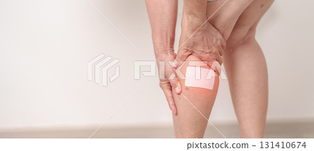 Elderly woman having Calf pain with Medicated pain relief patch plaster for concepts of Calf Muscle Strain, muscle pull, Leg Cramp, Sprain, aches, Varicose Veins, Deep Vein and world Thrombosis day Elderly woman having Calf pain with Medicated pain relief patch plaster for concepts of Calf Muscle Strain, muscle pull, Leg Cramp, Sprain, aches, Varicose Veins, Deep Vein and world Thrombosis day 131410674