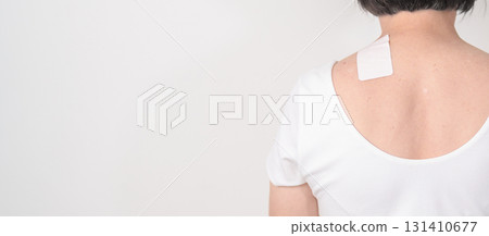 Elderly Woman having Shoulder Pain with Medicated pain relief patch plaster for Muscle Inflammation and Sprain, Myofascial ache syndrome and Fibromyalgia, Shoulder Myalgia and Scapular Tightness 131410677