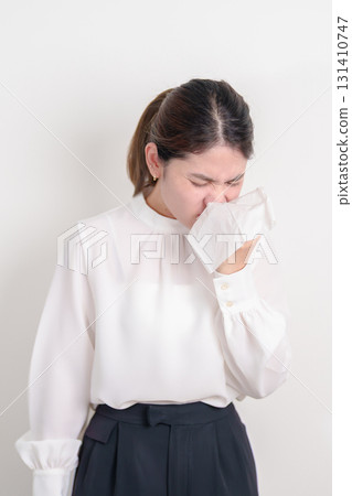business woman blowing her nose with tissue for concepts of Common Cold, Influenza, Flu, Hay, Fever, Covid 19, Respiratory Infection, Sinusitis, Allergic Rhinitis, Allergy, Medical and health care 131410747