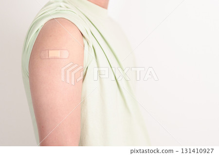 Adult Man with bandage after received vaccine. Vaccination and Immunization for Influenza, HPV, Zoster, IPD, DTP or Diphtheria, Tetanus and Pertussis, MMR, Hepatitis B, Covid and Varicella vaccine 131410927