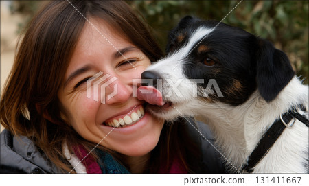 Smiling woman shares a joyful moment as her dog affectionately licks her cheek Smiling woman shares a joyful moment as her dog affectionately licks her cheek 131411667