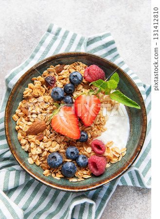 Granola bowl with yogurt, berries, and mint 131412810