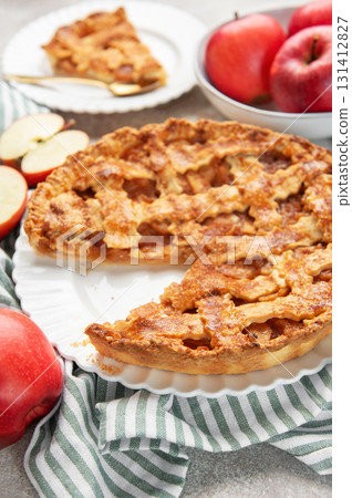Homemade apple pie with a slice and fresh apples Homemade apple pie with a slice and fresh apples 131412827