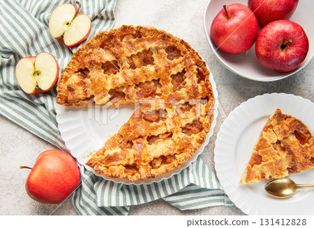 Homemade apple pie with a slice and fresh apples 131412828