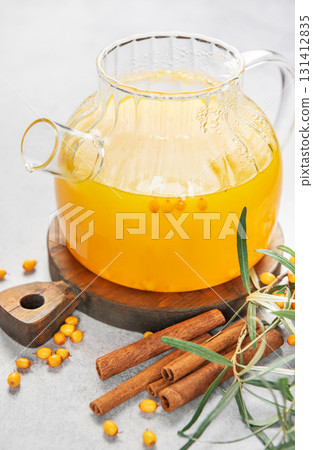 Sea buckthorn tea in teapot with cinnamon and berries Sea buckthorn tea in teapot with cinnamon and berries 131412835