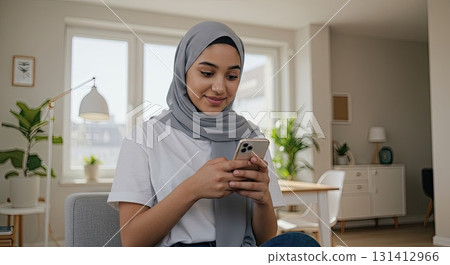 Muslim woman uses smartphone, enjoying positive digital connection, social connection 131412966