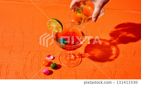 A vibrant, colorful cocktail being poured into a glass. Mixology, creative cocktails, bartender, party, celebration. A vibrant, colorful cocktail being poured into a glass. Mixology, creative cocktails, bartender, party, celebration. 131413330