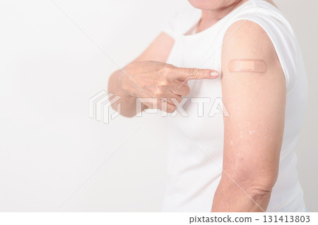 Elderly Woman with bandage after received vaccine. Vaccination and Immunization for Influenza, Herpes Zoster, Tetanus, Covid 19 booster, Dengue, Encephalitis, Rabies, Pneumococcal, IPD, RSV Vaccines 131413803