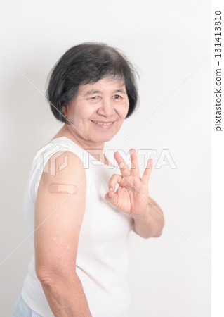 Elderly Woman with bandage after received vaccine. Vaccination and Immunization for Influenza, Herpes Zoster, Tetanus, Covid 19 booster, Dengue, Encephalitis, Rabies, Pneumococcal, IPD, RSV Vaccines 131413810