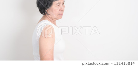 Elderly Woman with bandage after received vaccine. Vaccination and Immunization for Influenza, Herpes Zoster, Tetanus, Covid 19 booster, Dengue, Encephalitis, Rabies, Pneumococcal, IPD, RSV Vaccines 131413814